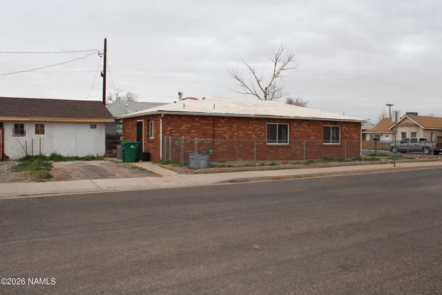a front view of a house with a street