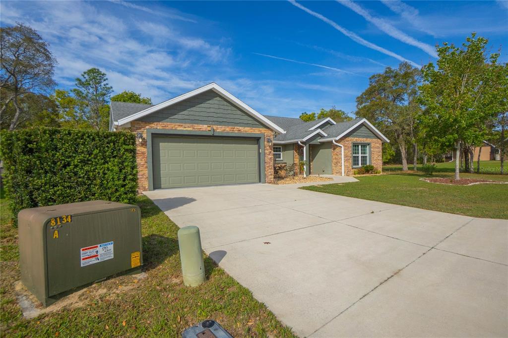 5466 West Tortuga Loop Lecanto, FL 34461 - Photo 3 of 41 a front view of a house with a yard