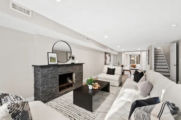 a living room with furniture and a fireplace