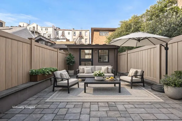 a view of a patio with couches table and chairs and potted plants