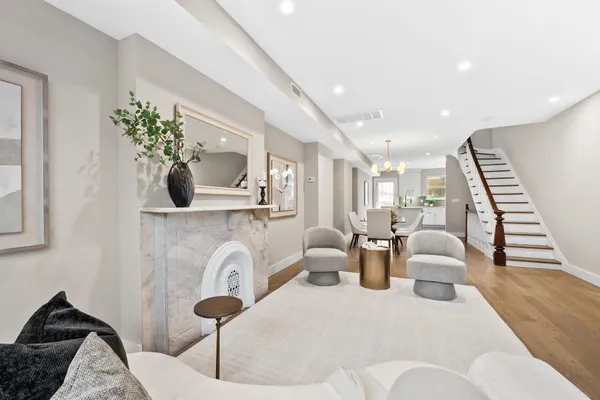 a living room with furniture and potted plants