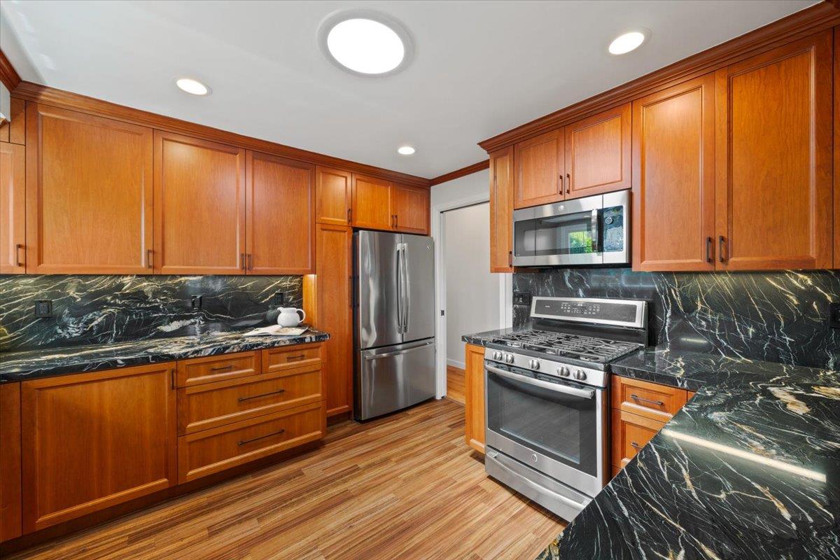 3530 Casanova Drive San Mateo, CA 94403 - Photo 18 of 50 a kitchen with stainless steel appliances granite countertop a stove a refrigerator and a microwave