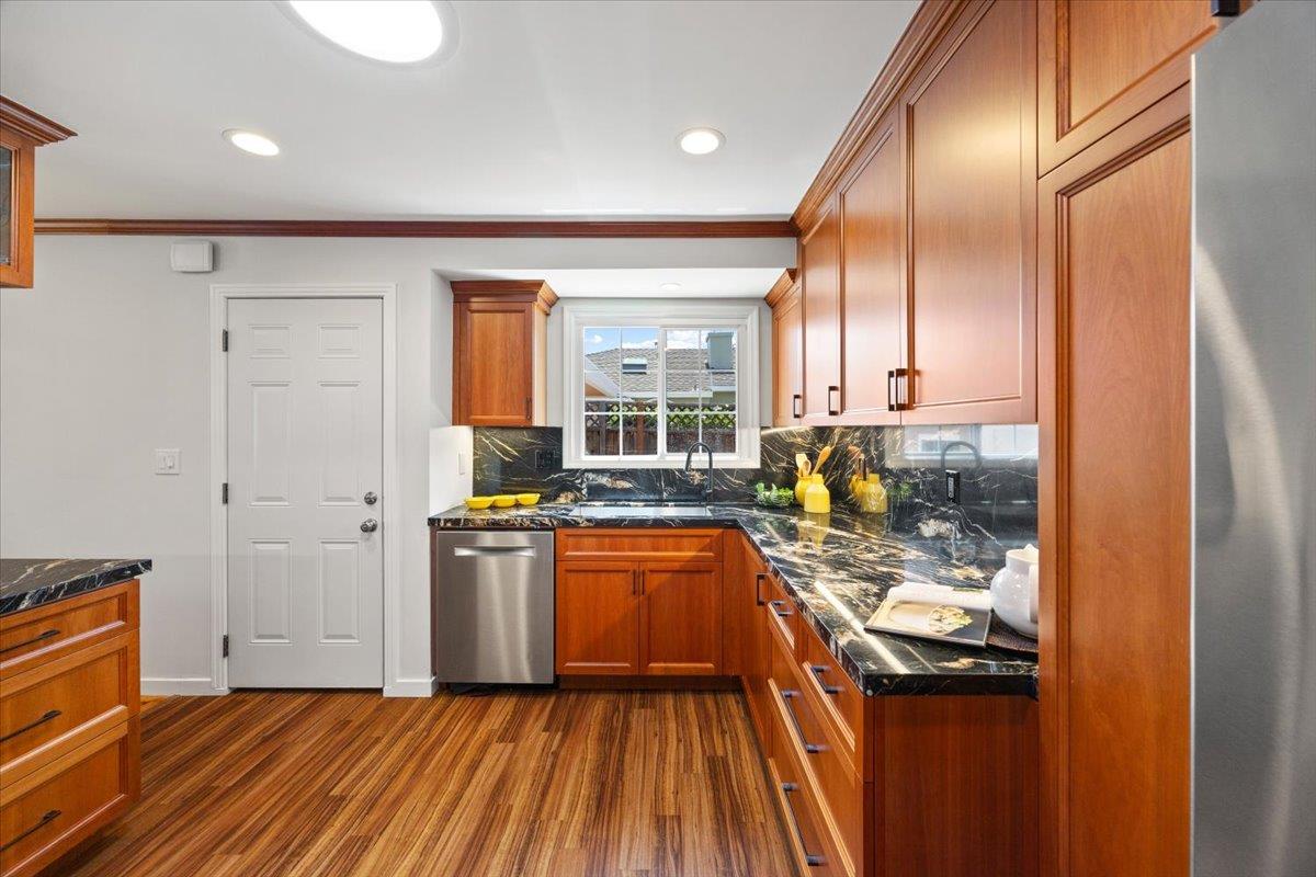 3530 Casanova Drive San Mateo, CA 94403 - Photo 19 of 50 a kitchen with stainless steel appliances granite countertop a stove a sink and a refrigerator