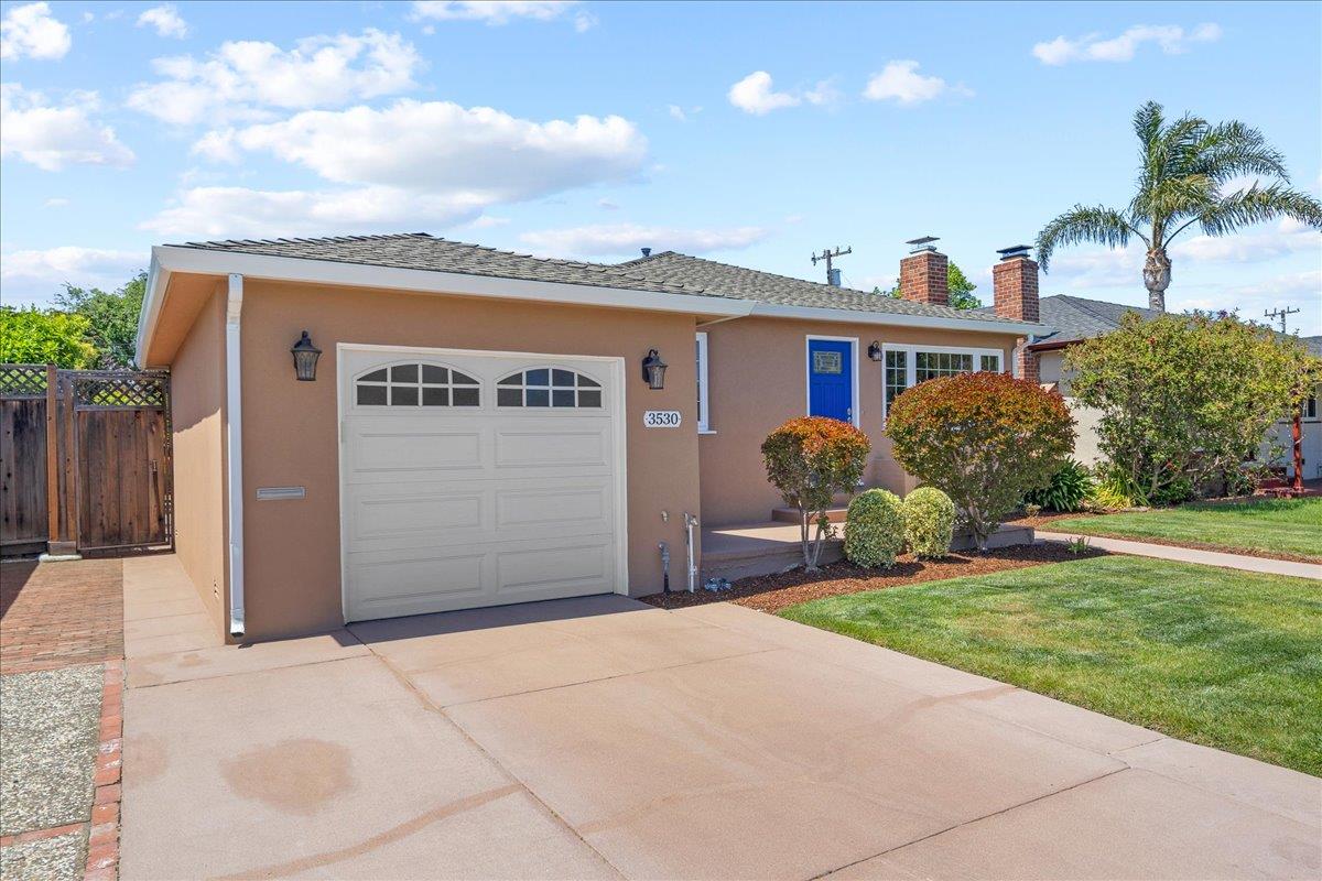3530 Casanova Drive San Mateo, CA 94403 - Photo 7 of 50 a front view of a house with a yard and garage