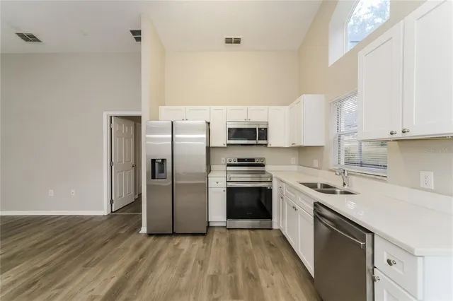 a kitchen with stainless steel appliances and wooden cabinets