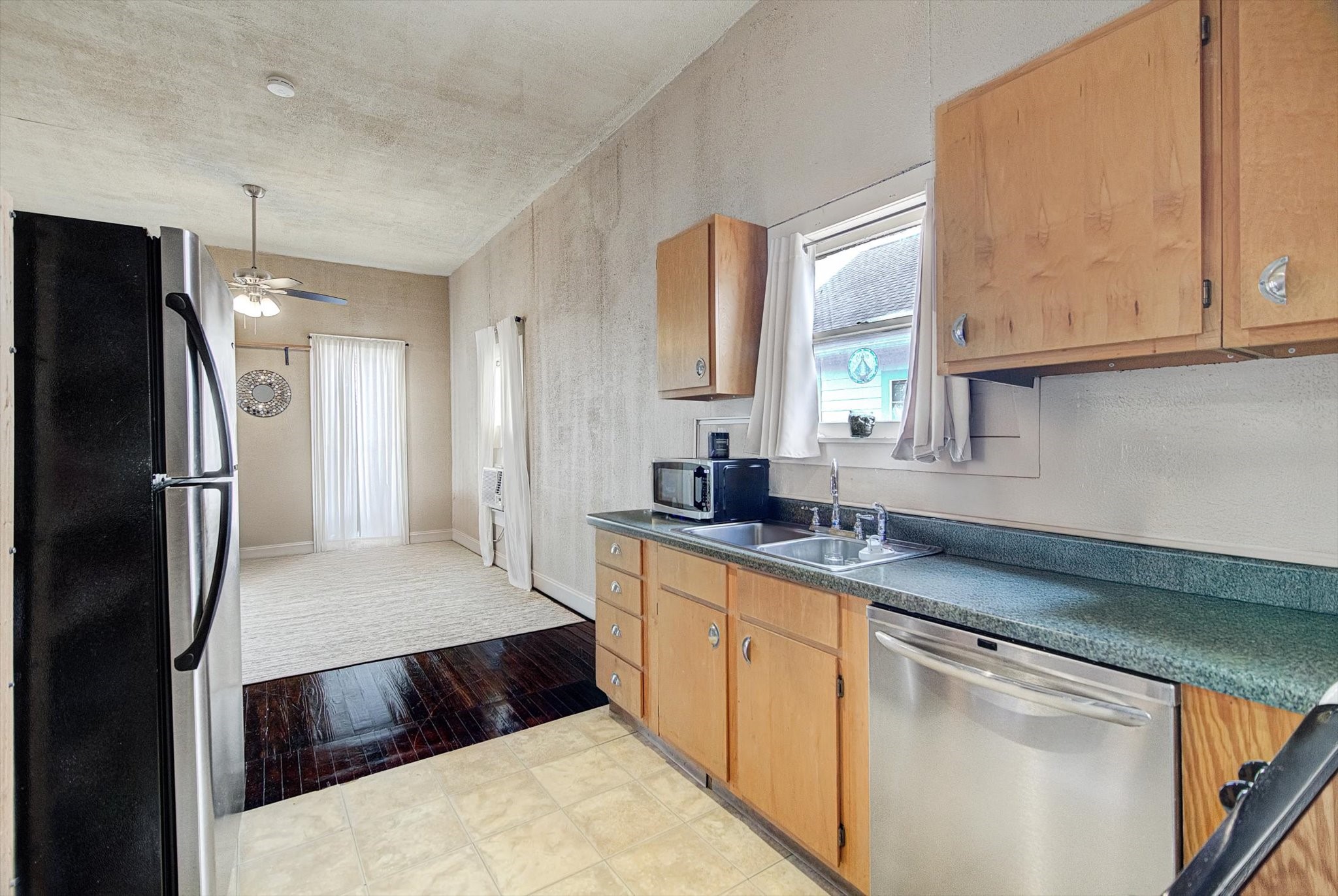 515 Bishop Street Houston, TX 77009 - Photo 7 of 18 a kitchen with stainless steel appliances a sink stove and refrigerator