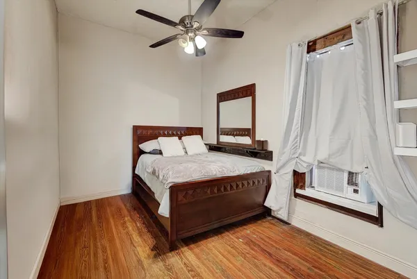a bedroom with a bed and a window