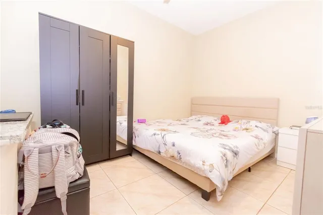 a bedroom with a bed and chair