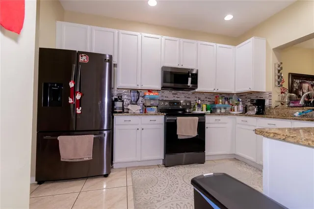 a kitchen with stainless steel appliances granite countertop a refrigerator oven a sink and dishwasher