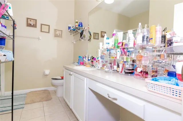 a bathroom with a sink mirror vanity and toilet