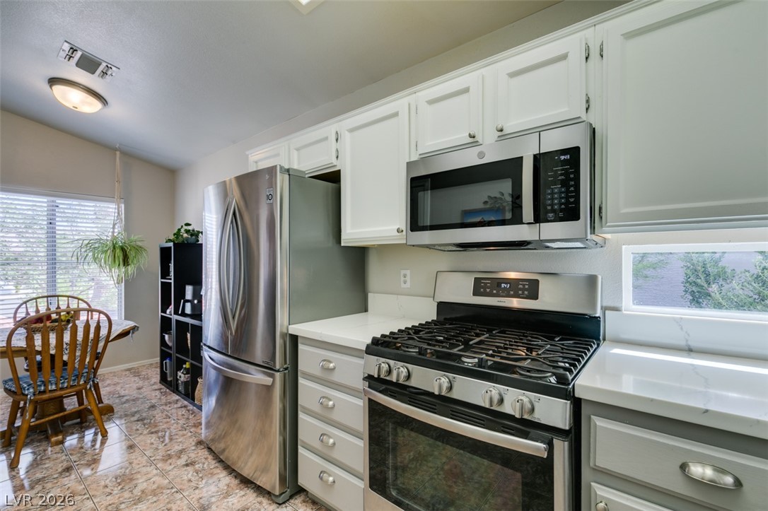 2187 Chapman Ranch Drive Henderson, NV 89012 - Photo 11 of 26 This bright kitchen features modern stainless steel appliances and durable tile flooring.