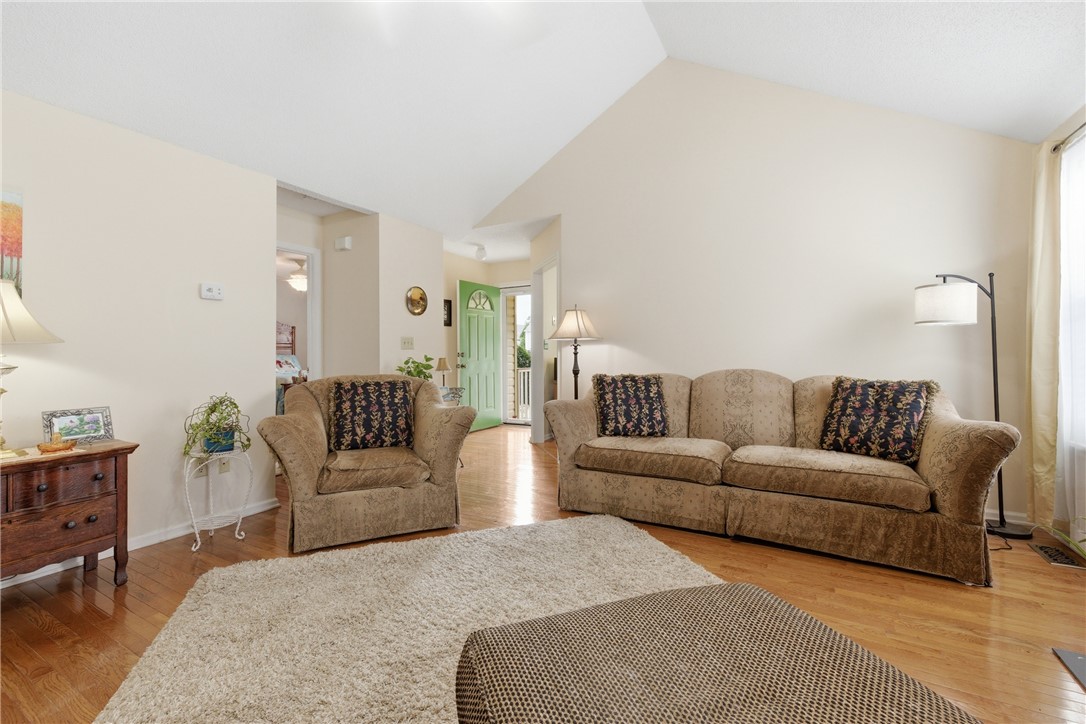 128 Kelly Lane Easley, SC 29642 - Photo 12 of 23 Hardwood floors and a vaulted ceiling elevate this comfortable living space, leading to a bright entry.