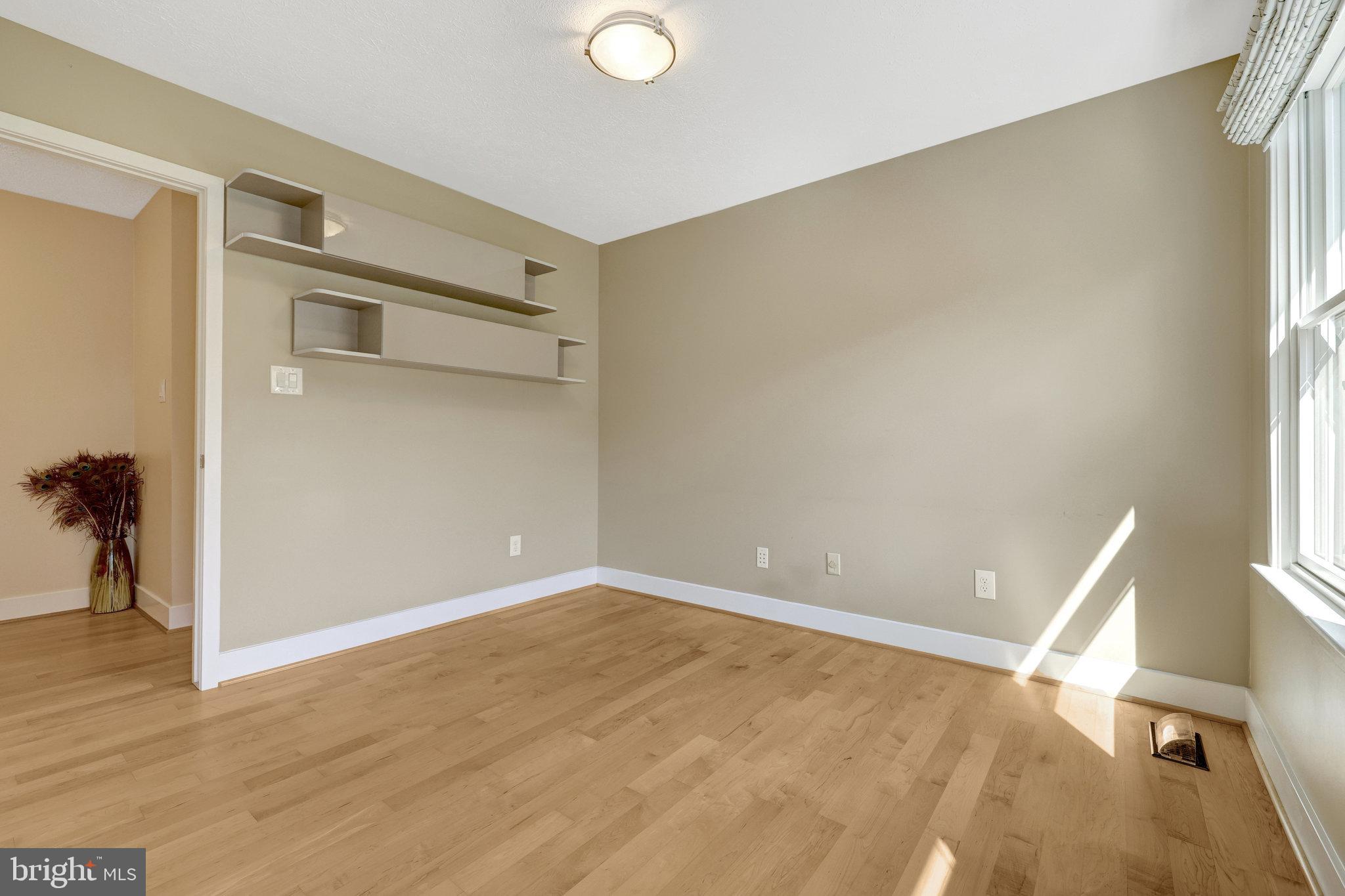 11637 Quail Ridge Court Reston, VA 20194 - Photo 20 of 40 a view of an empty room with wooden floor and a window