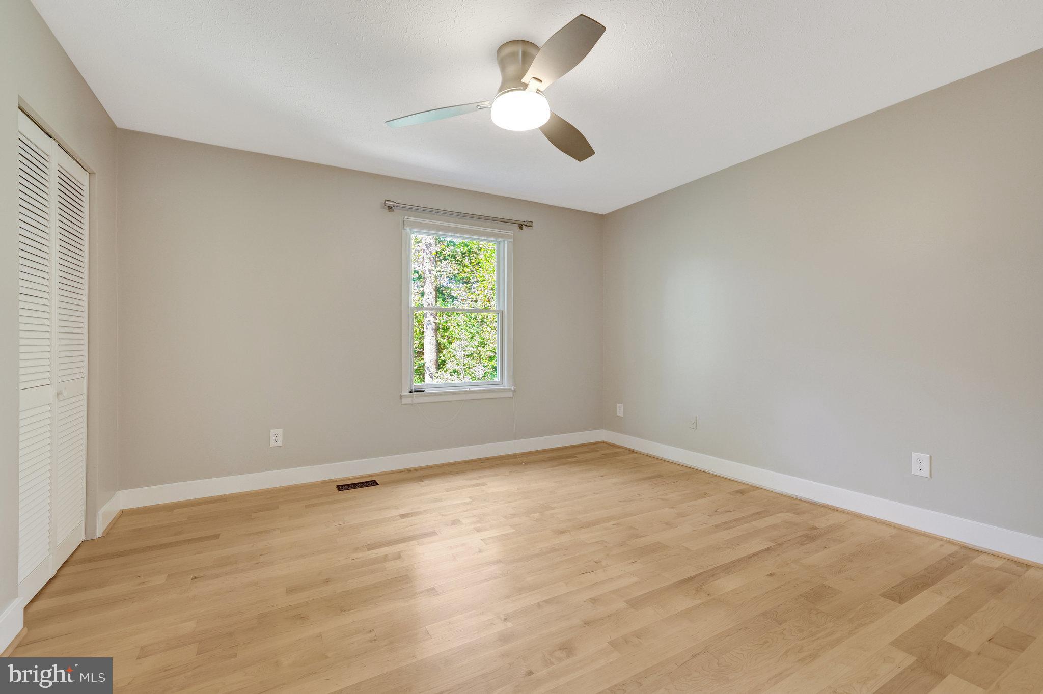 11637 Quail Ridge Court Reston, VA 20194 - Photo 23 of 40 an empty room with a window and a fan