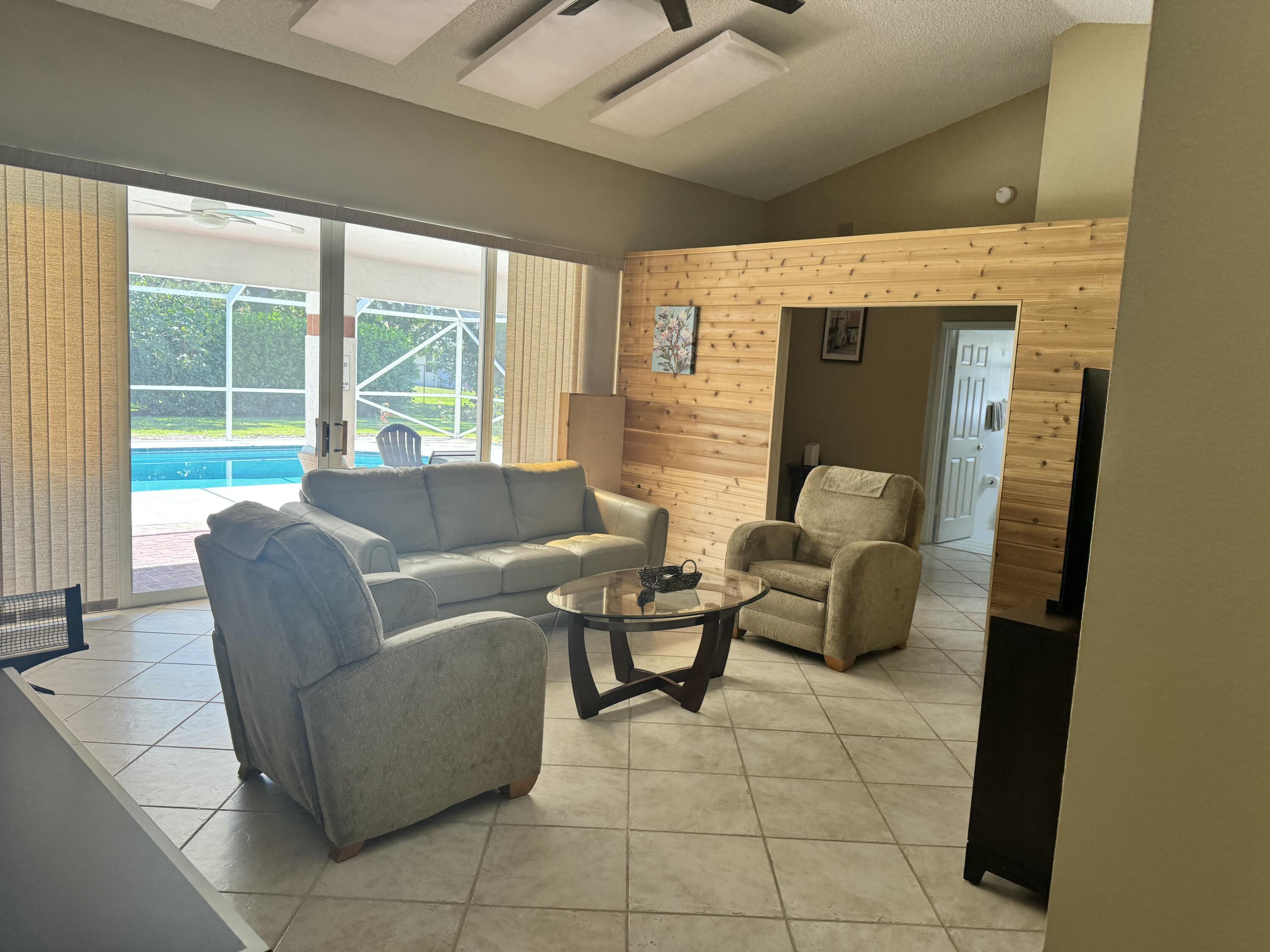 2937 Southeast Cates Circle Port St. Lucie, FL 34952 - Photo 17 of 43 a living room with furniture and large windows