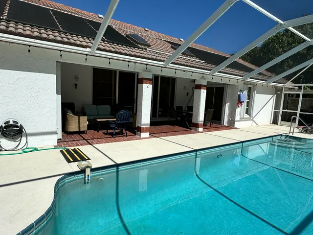 a view of a patio with a table and chairs