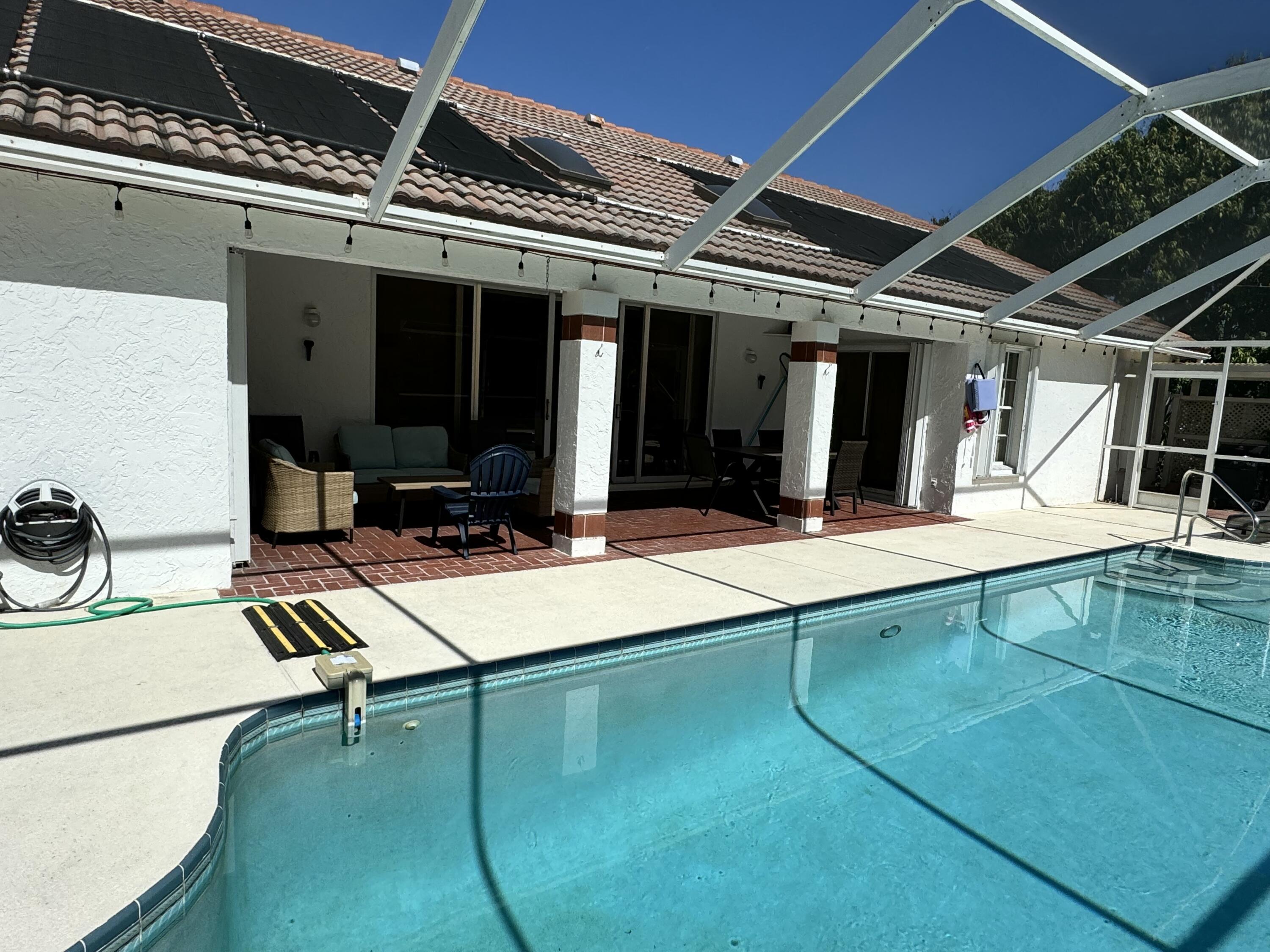 2937 Southeast Cates Circle Port St. Lucie, FL 34952 - Photo 2 of 43 a view of a patio with a table and chairs