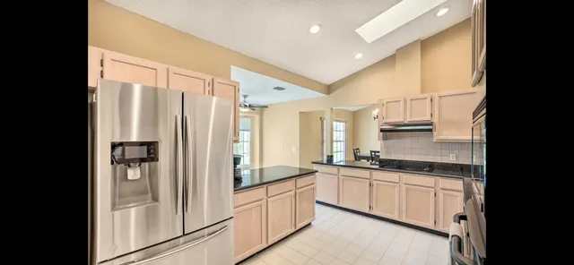 a bedroom with a bed gym equipment and a flat tv screen