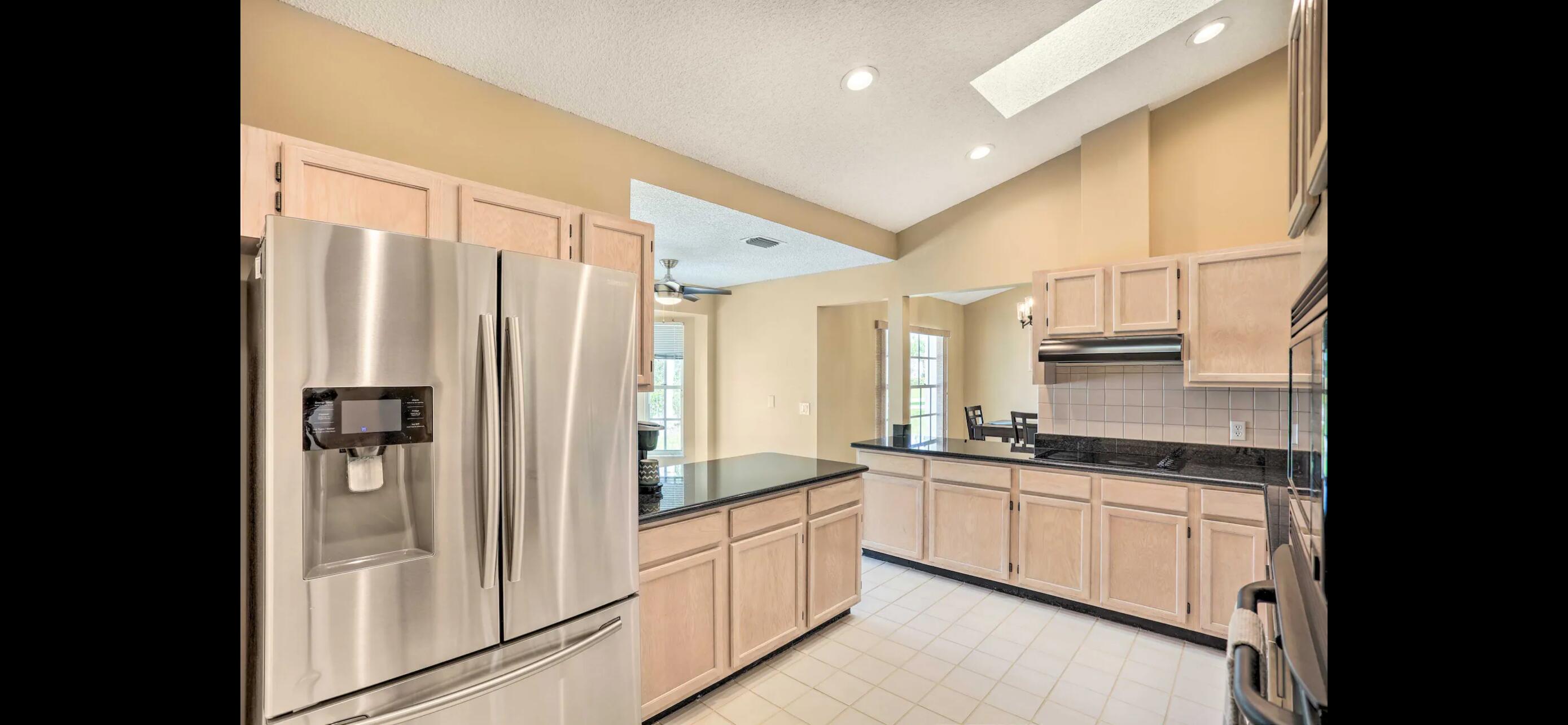2937 Southeast Cates Circle Port St. Lucie, FL 34952 - Photo 22 of 43 a kitchen with stainless steel appliances a refrigerator sink and cabinets