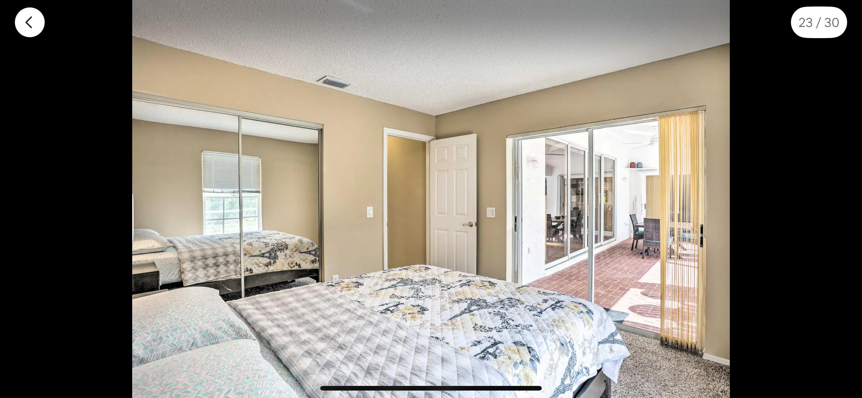 2937 Southeast Cates Circle Port St. Lucie, FL 34952 - Photo 32 of 43 a bedroom with a bed and glass walk in closet