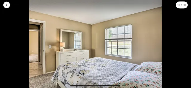 a living room with furniture and large windows