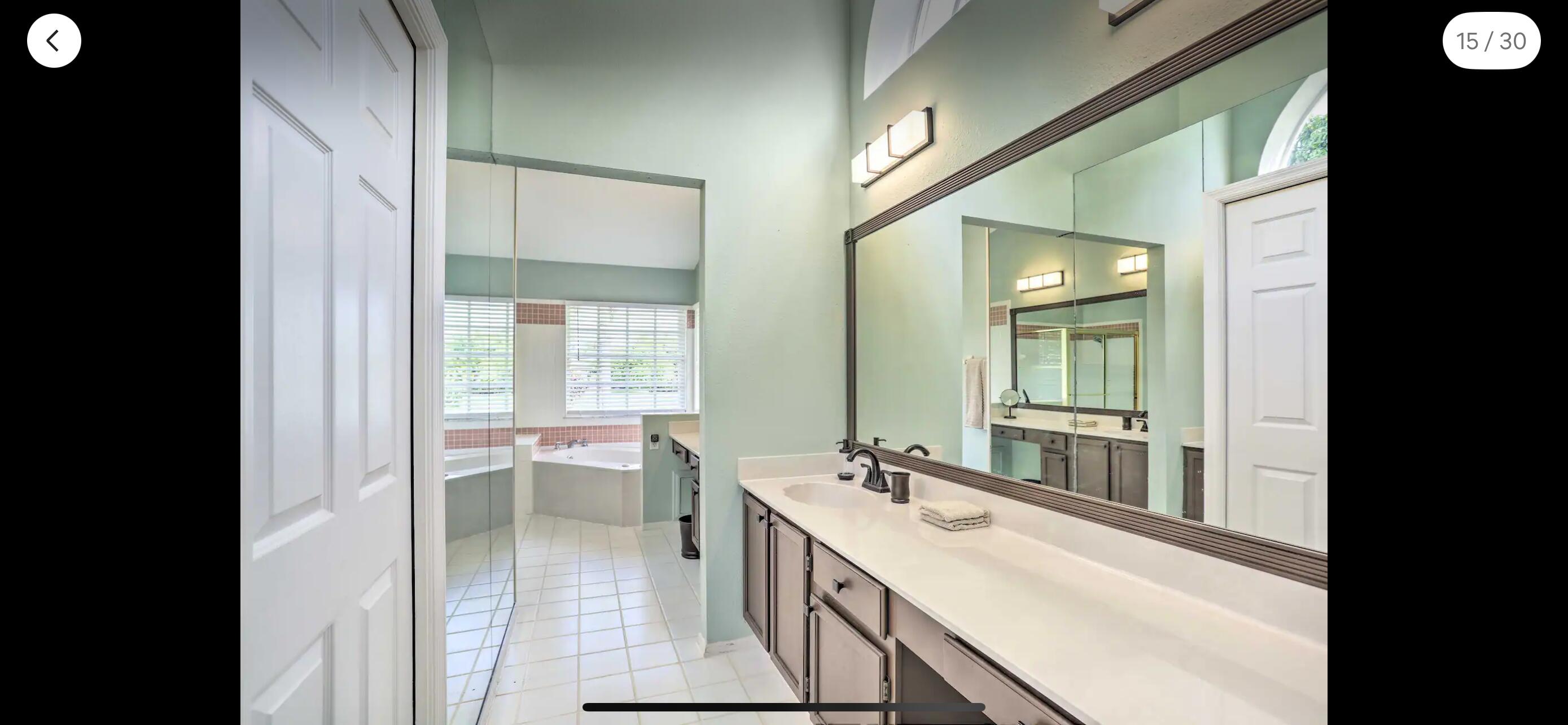2937 Southeast Cates Circle Port St. Lucie, FL 34952 - Photo 35 of 43 a bathroom with a double vanity sink and a mirror
