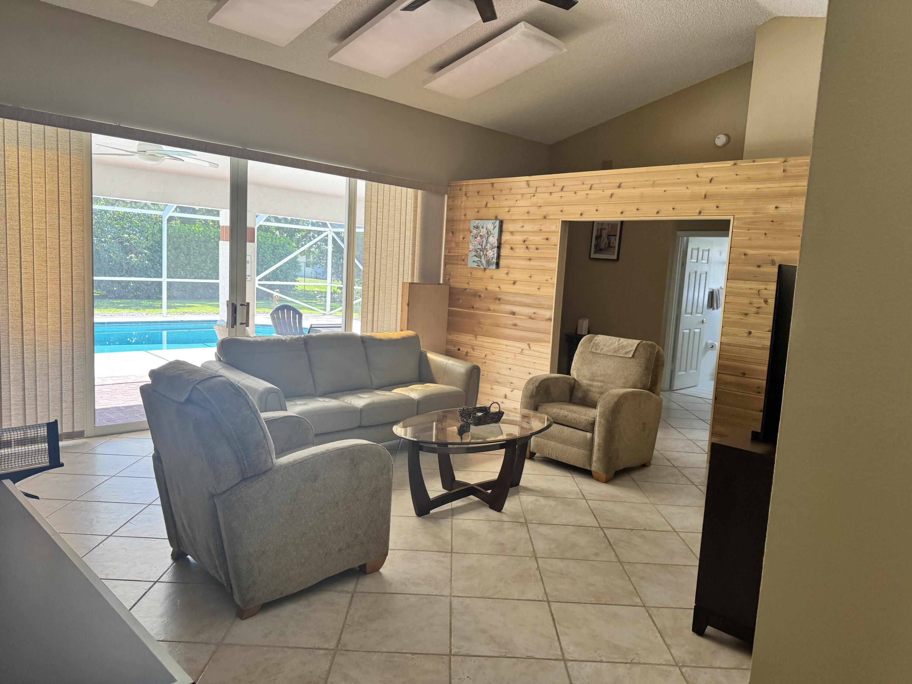 2937 Southeast Cates Circle Port St. Lucie, FL 34952 - Photo 37 of 43 a living room with furniture and large windows