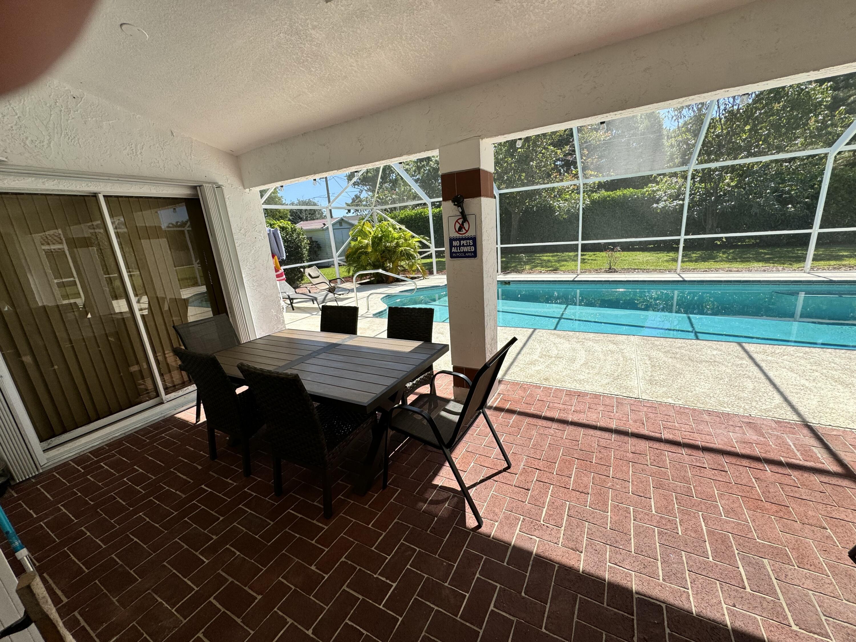 2937 Southeast Cates Circle Port St. Lucie, FL 34952 - Photo 6 of 43 a view of a patio with table and chairs