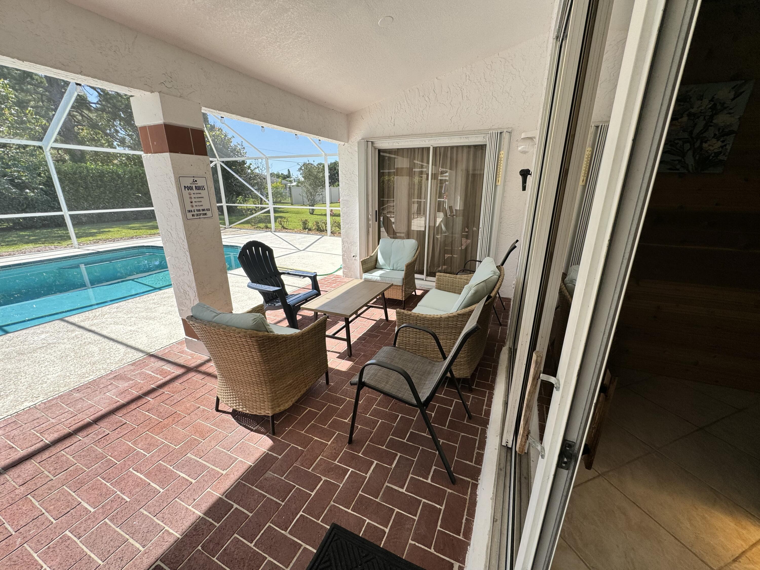2937 Southeast Cates Circle Port St. Lucie, FL 34952 - Photo 7 of 43 a living room with a couch and a large window