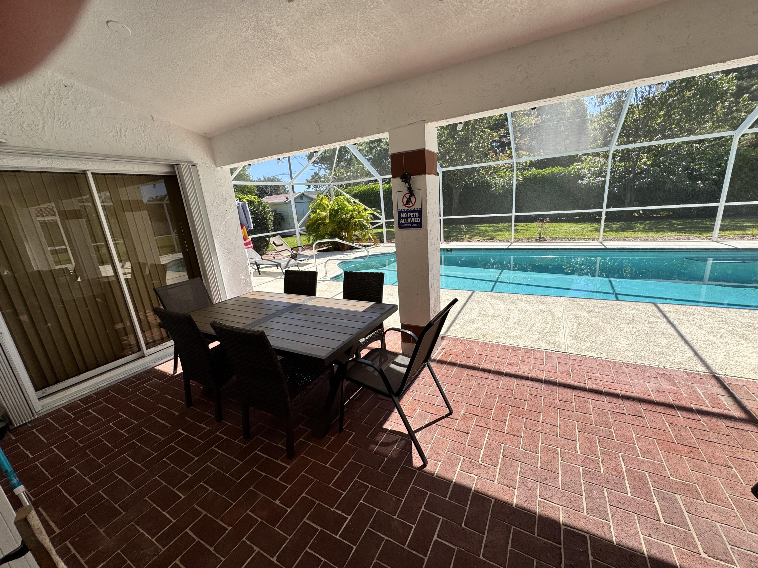 2937 Southeast Cates Circle Port St. Lucie, FL 34952 - Photo 8 of 43 a view of a patio with table and chairs