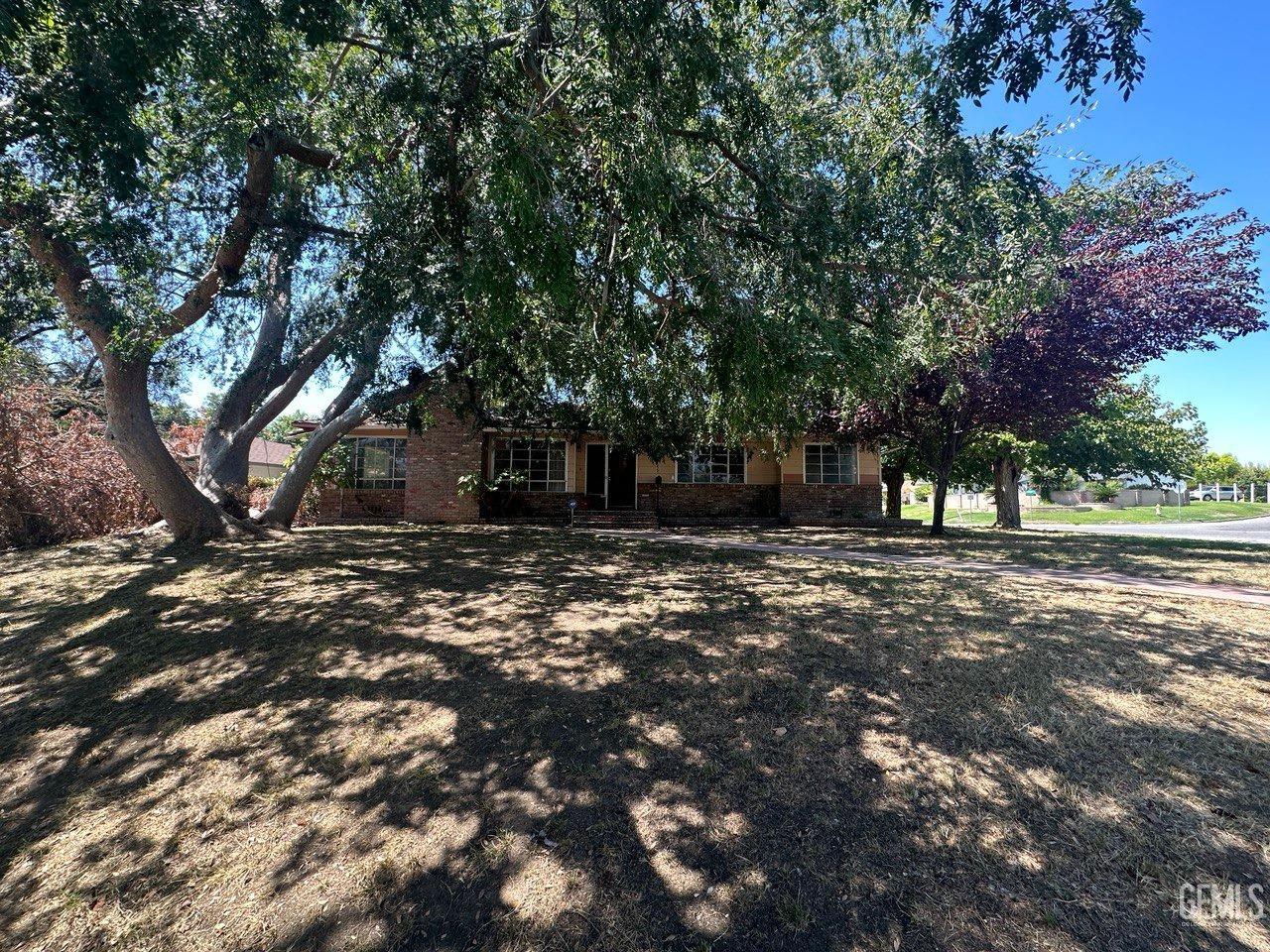 Undisclosed Address Bakersfield, CA 93306 - Photo 2 of 16 a view of a tree in front of a house