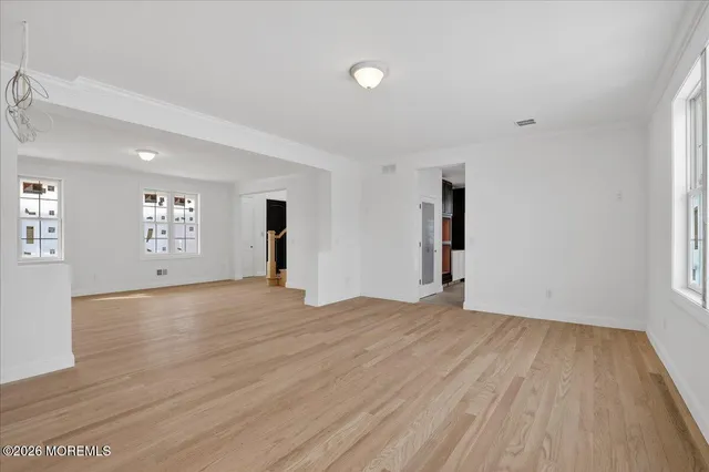 an empty room with windows and closet