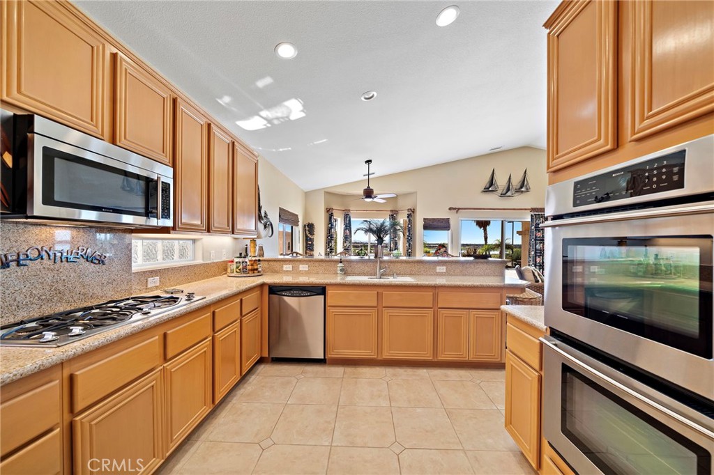 2710 Colorado River Road Blythe, CA 92225 - Photo 18 of 43 a kitchen with stainless steel appliances granite countertop a stove and a microwave