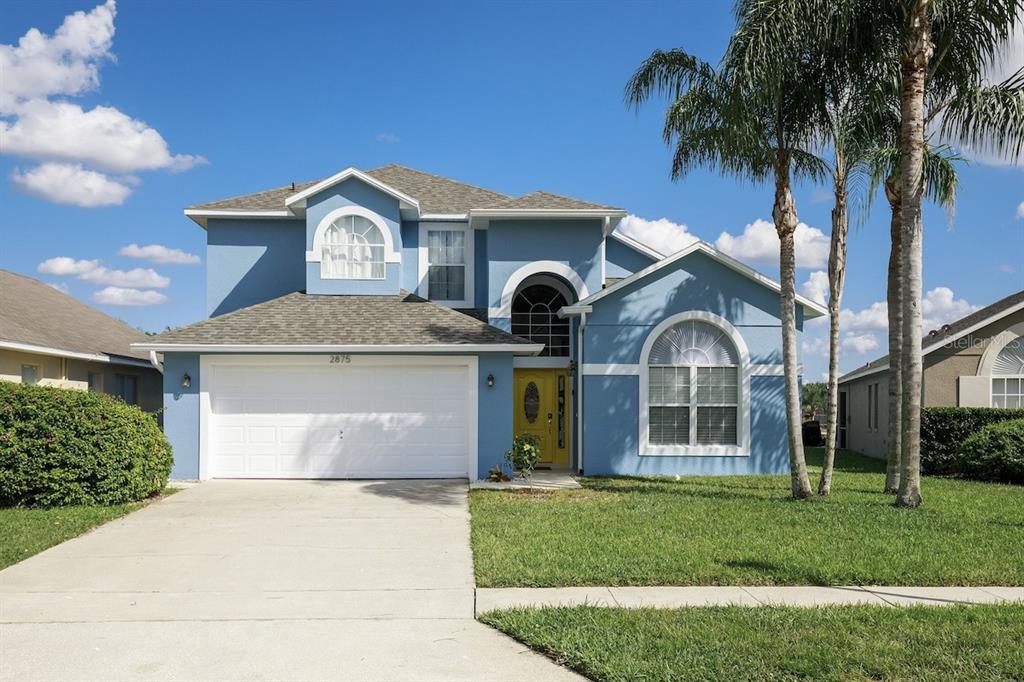a front view of a house with a garden and plants