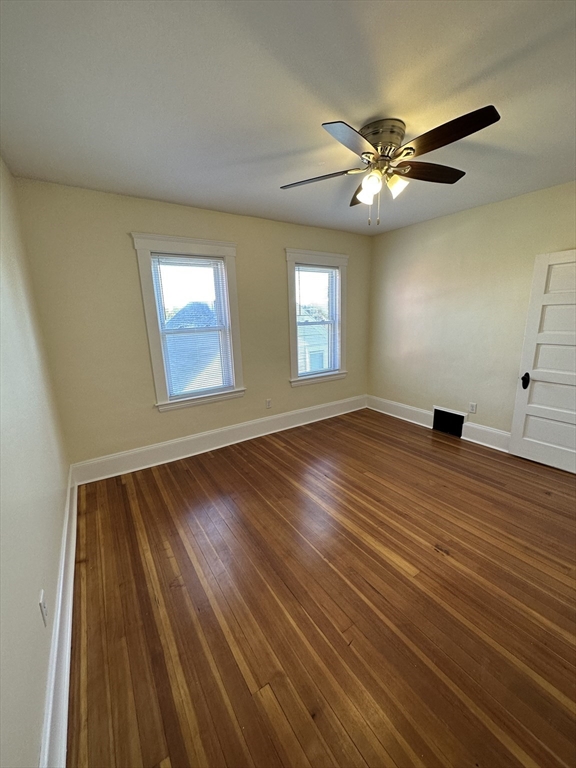 35 George Street, Unit 3 Everett, MA 02149 - Photo 12 of 34 a view of an empty room with wooden floor and a window
