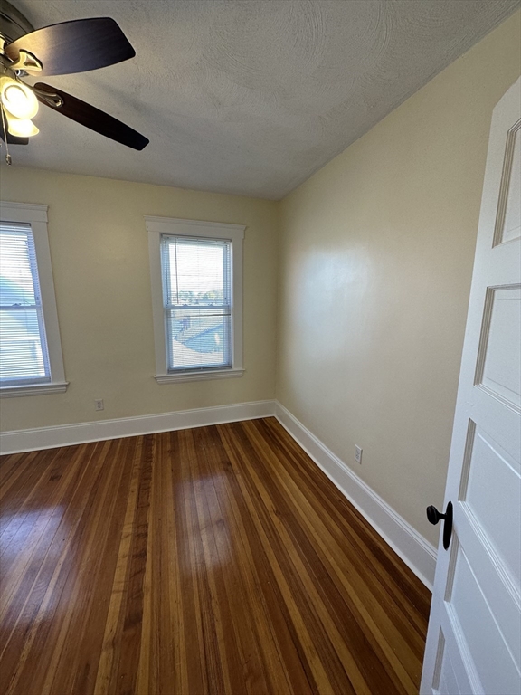 35 George Street, Unit 3 Everett, MA 02149 - Photo 17 of 34 an empty room with wooden floor and windows
