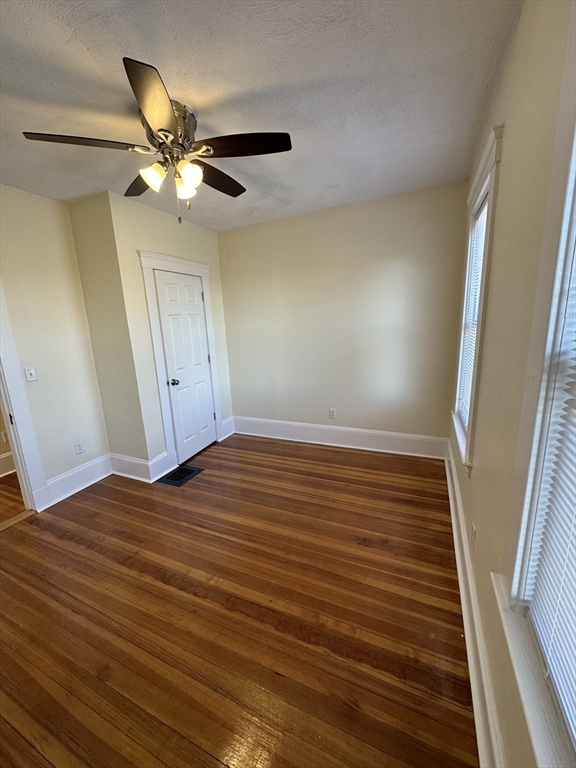 35 George Street, Unit 3 Everett, MA 02149 - Photo 18 of 34 a view of an empty room with wooden floor and a ceiling fan