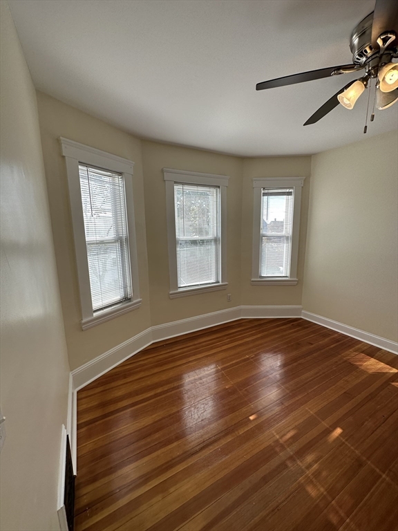 35 George Street, Unit 3 Everett, MA 02149 - Photo 27 of 34 a view of an empty room with wooden floor and a window