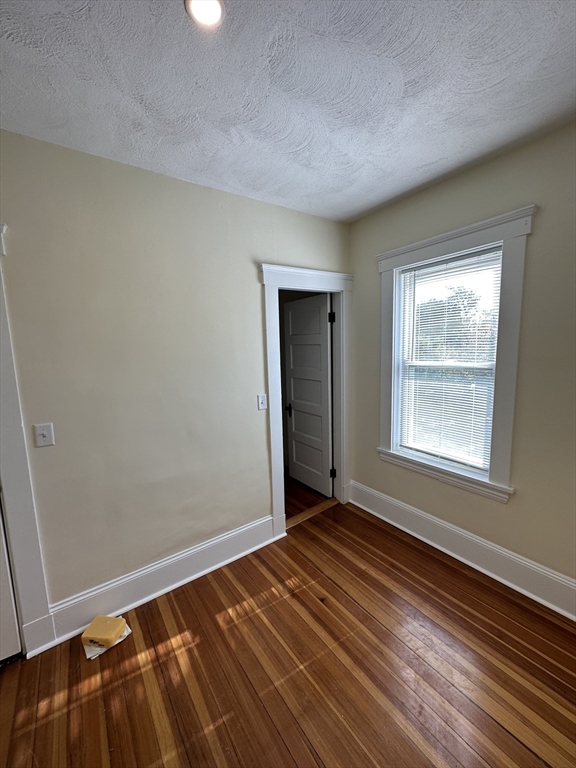 35 George Street, Unit 3 Everett, MA 02149 - Photo 33 of 34 a view of an empty room with wooden floor and a window