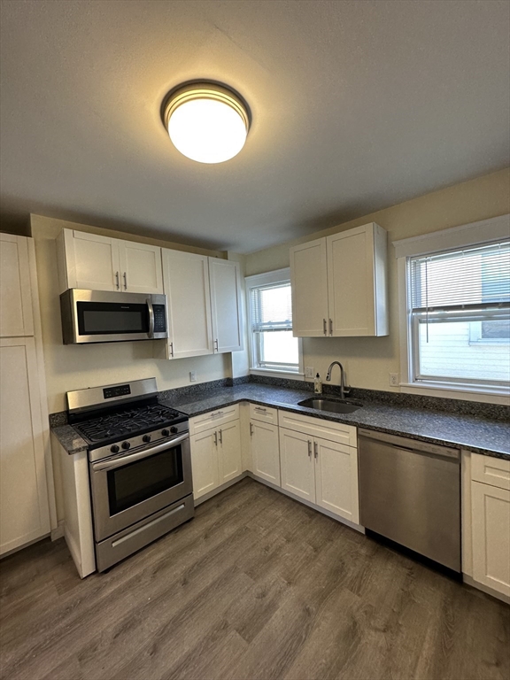 35 George Street, Unit 3 Everett, MA 02149 - Photo 4 of 34 a kitchen with stainless steel appliances granite countertop a stove a sink and a microwave