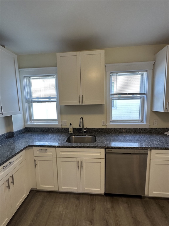 35 George Street, Unit 3 Everett, MA 02149 - Photo 7 of 34 a kitchen with granite countertop white cabinets white appliances a sink and a window