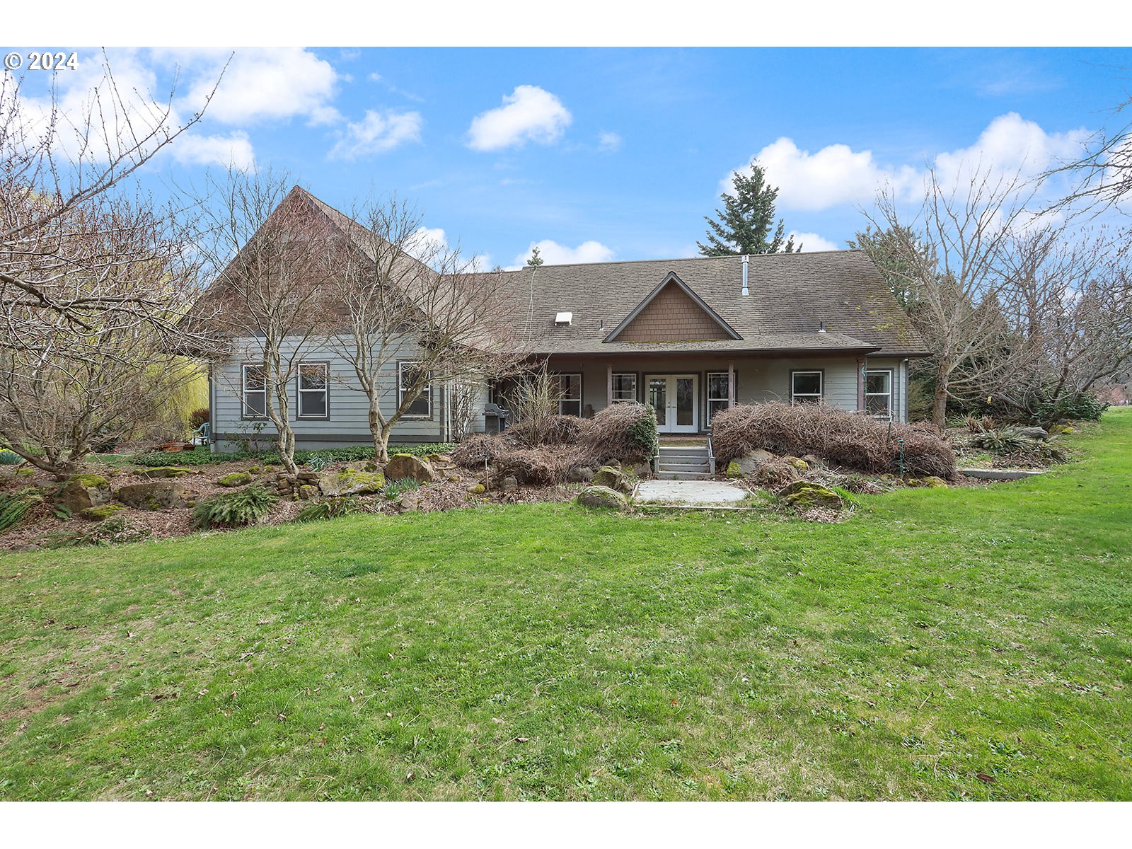 1190 Methodist Road Hood River, OR 97031 - Photo 1 of 41 a front view of a house with a garden and patio