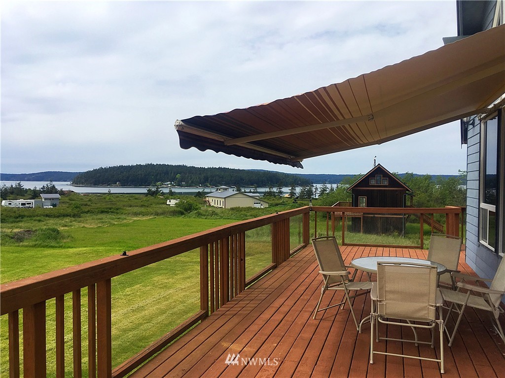 44 Beach Court Decatur Island, WA 98221 - Photo 1 of 25 a view of a balcony with wooden floor and outdoor space
