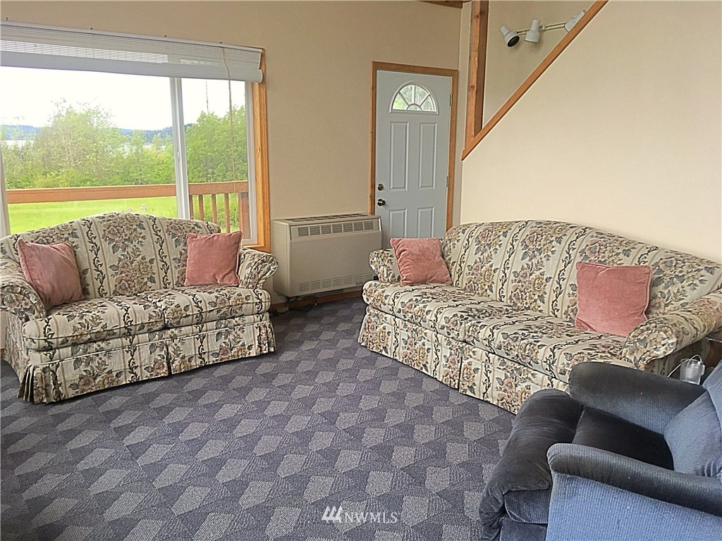 44 Beach Court Decatur Island, WA 98221 - Photo 13 of 25 a living room with furniture and a large window