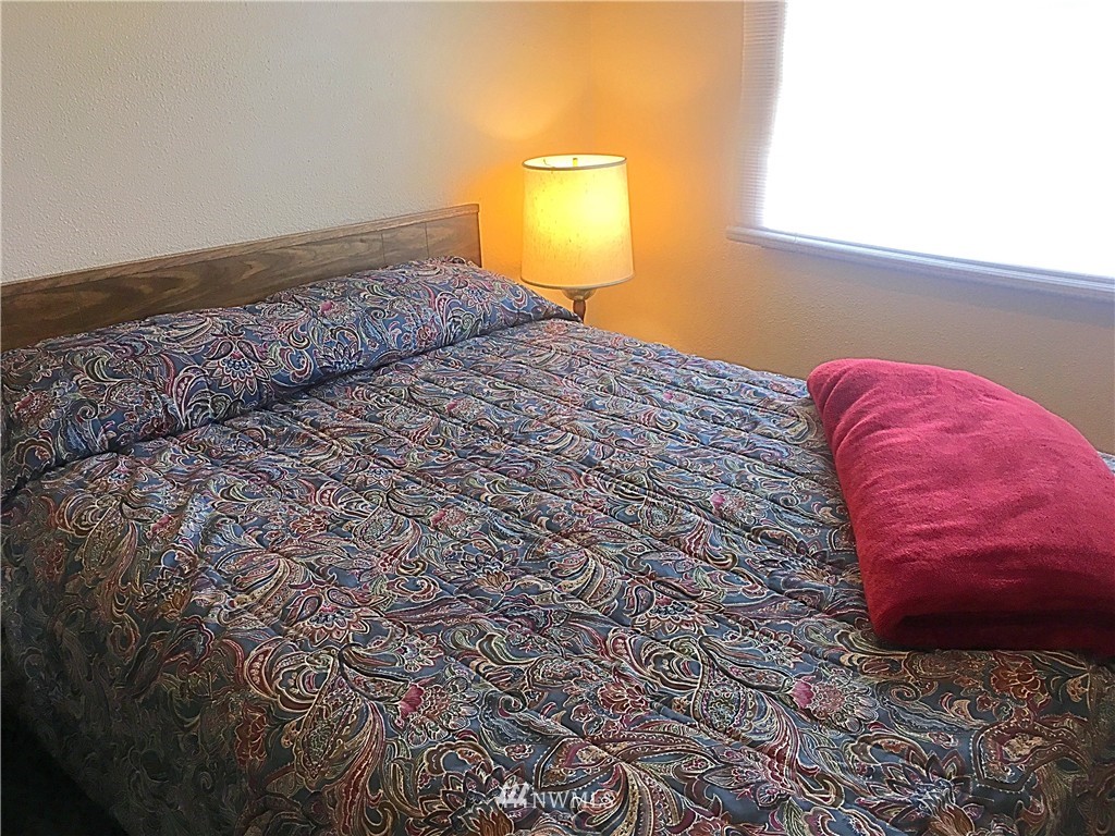 44 Beach Court Decatur Island, WA 98221 - Photo 14 of 25 a bedroom with a bed and a window