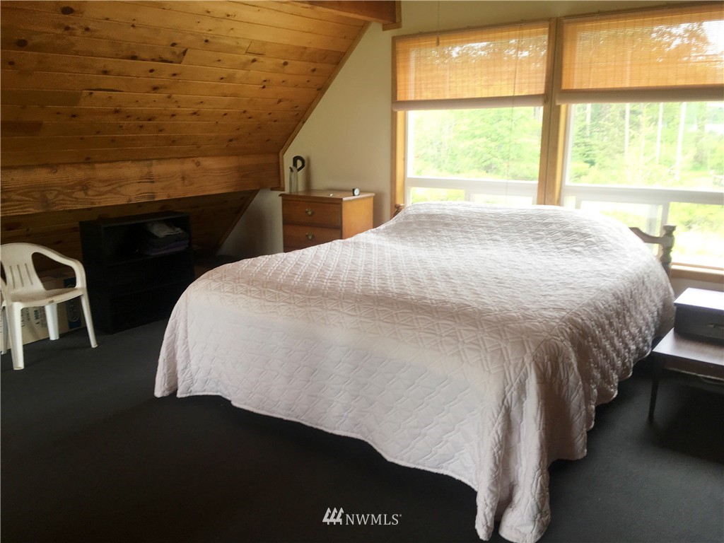 44 Beach Court Decatur Island, WA 98221 - Photo 16 of 25 a bed sitting in a bedroom next to a window
