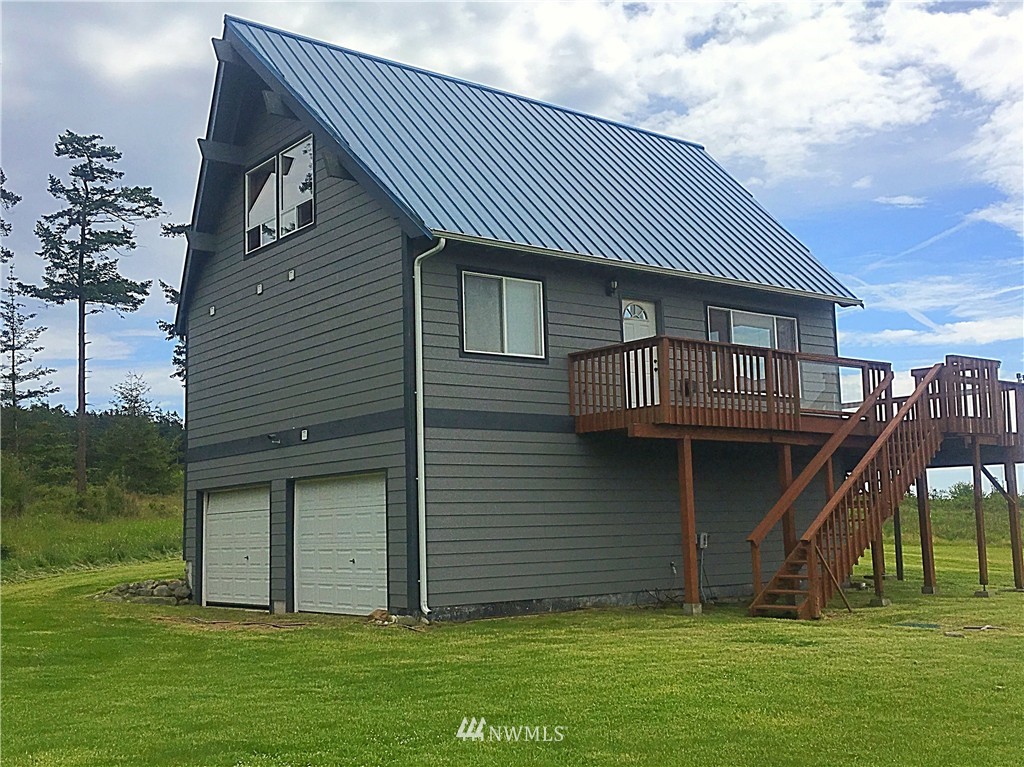 44 Beach Court Decatur Island, WA 98221 - Photo 19 of 25 a front view of a house with a garden