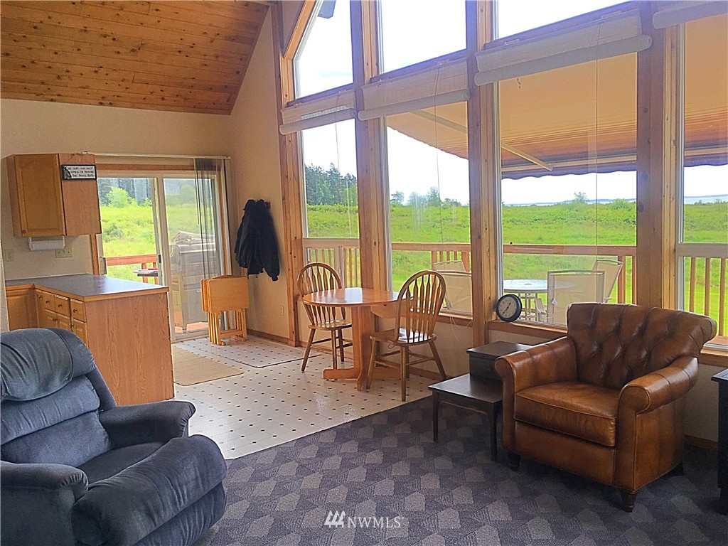 44 Beach Court Decatur Island, WA 98221 - Photo 3 of 25 a living room with furniture and floor to ceiling windows