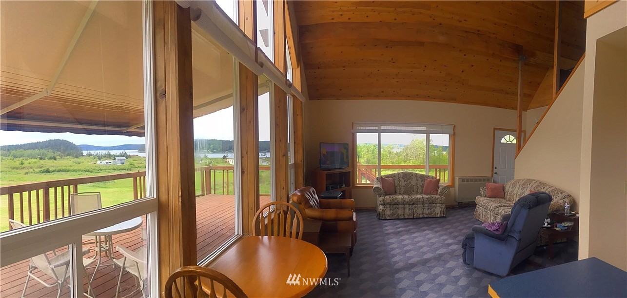 44 Beach Court Decatur Island, WA 98221 - Photo 5 of 25 a living room with furniture floor to ceiling window and floor to ceiling window