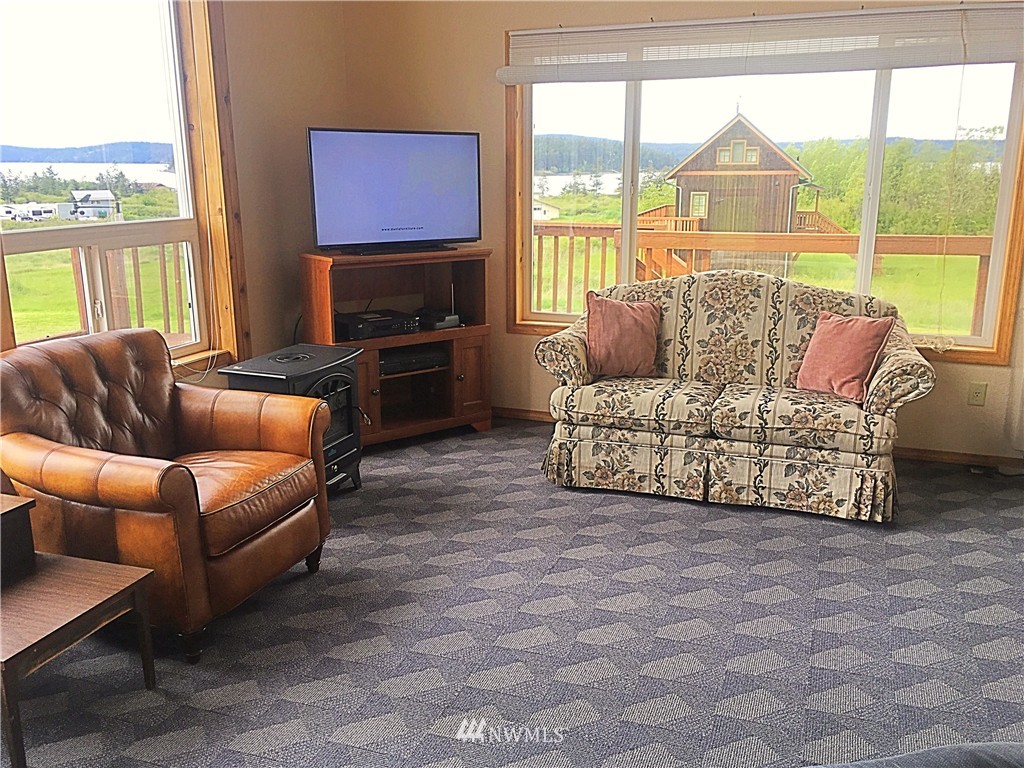 44 Beach Court Decatur Island, WA 98221 - Photo 7 of 25 a living room with furniture and a flat screen tv